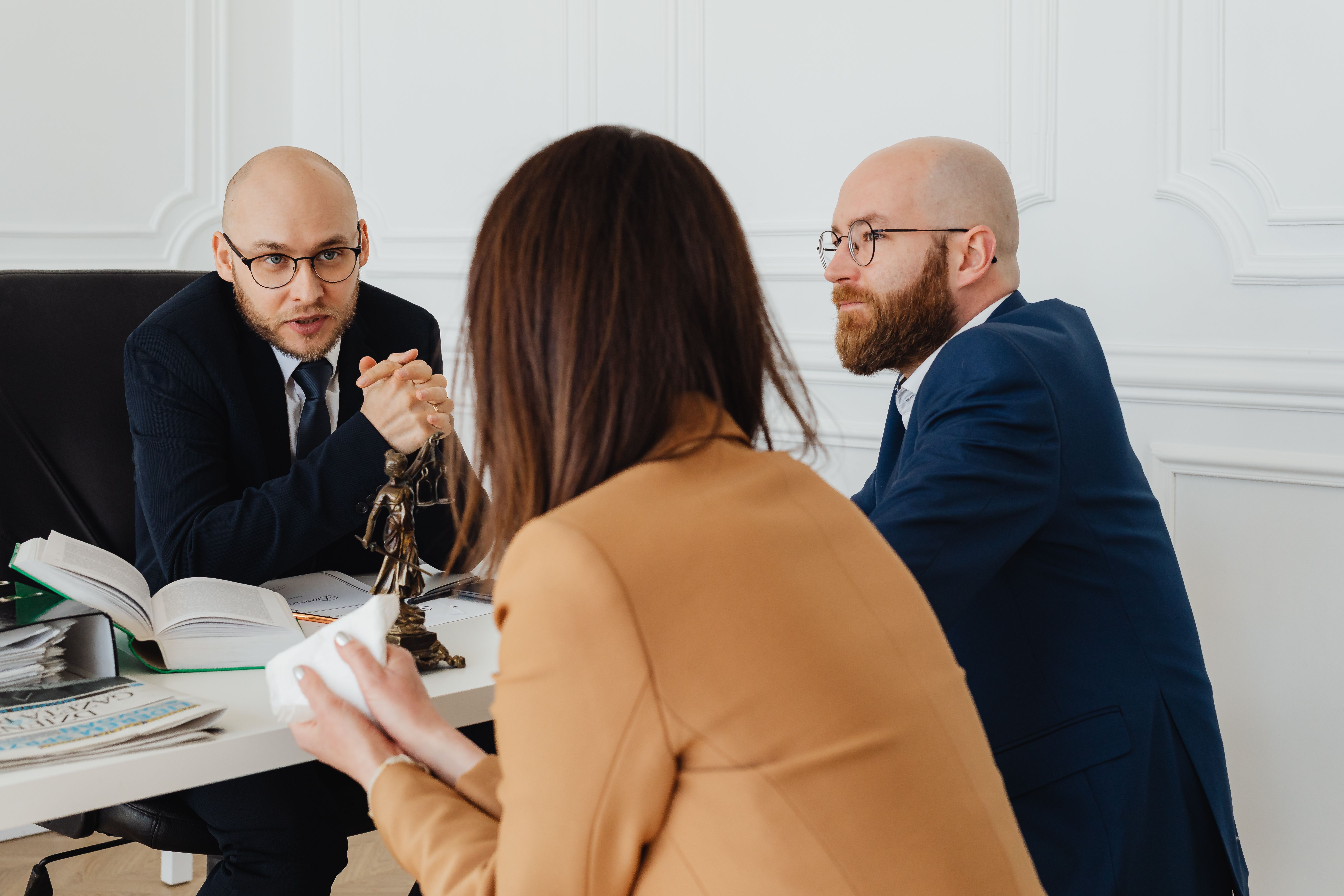 Lawyers discussing legal matters in a modern office during a class action lawsuit