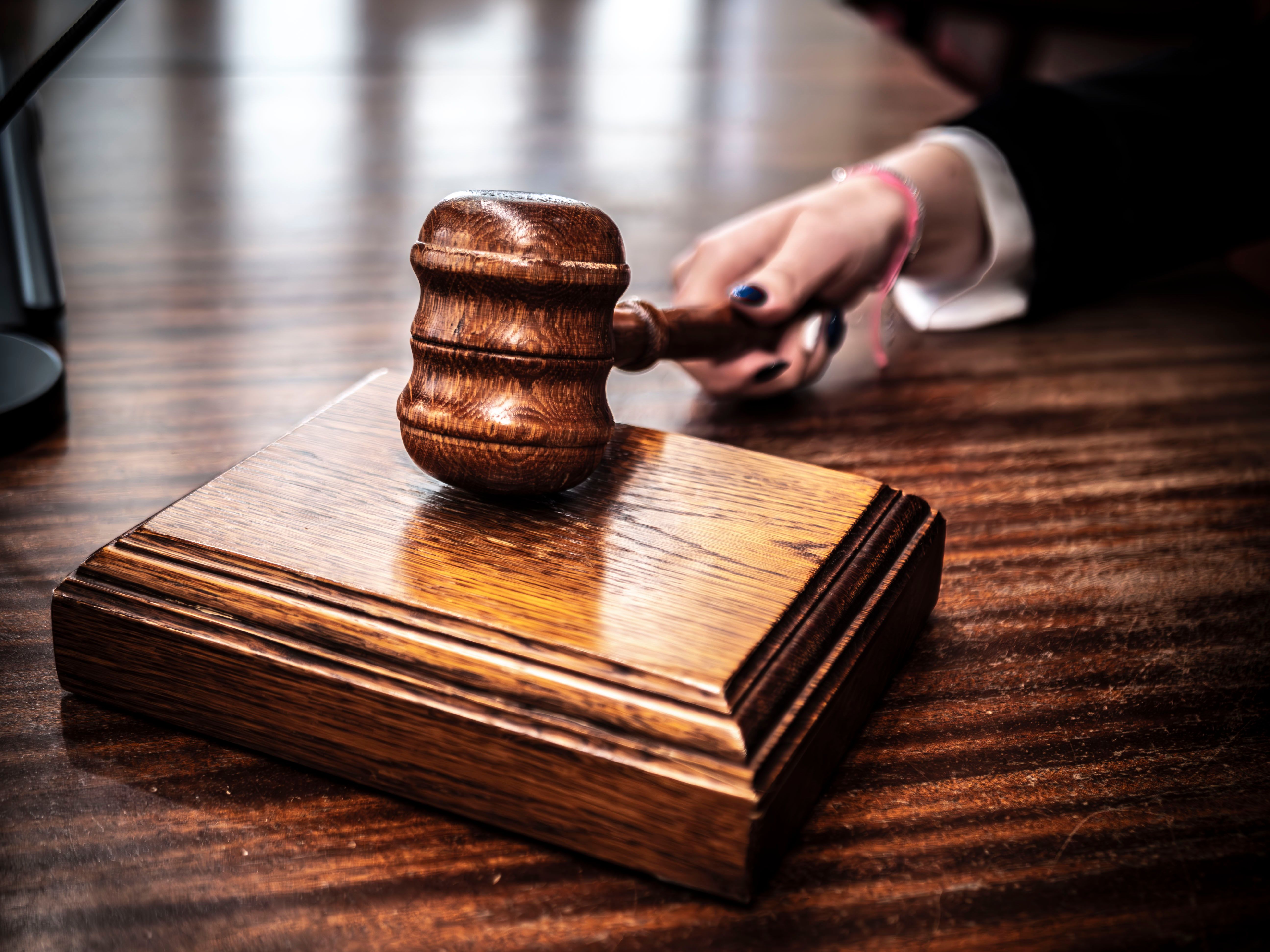Wooden gavel on a judge's desk symbolizing class action lawsuit courtroom justice