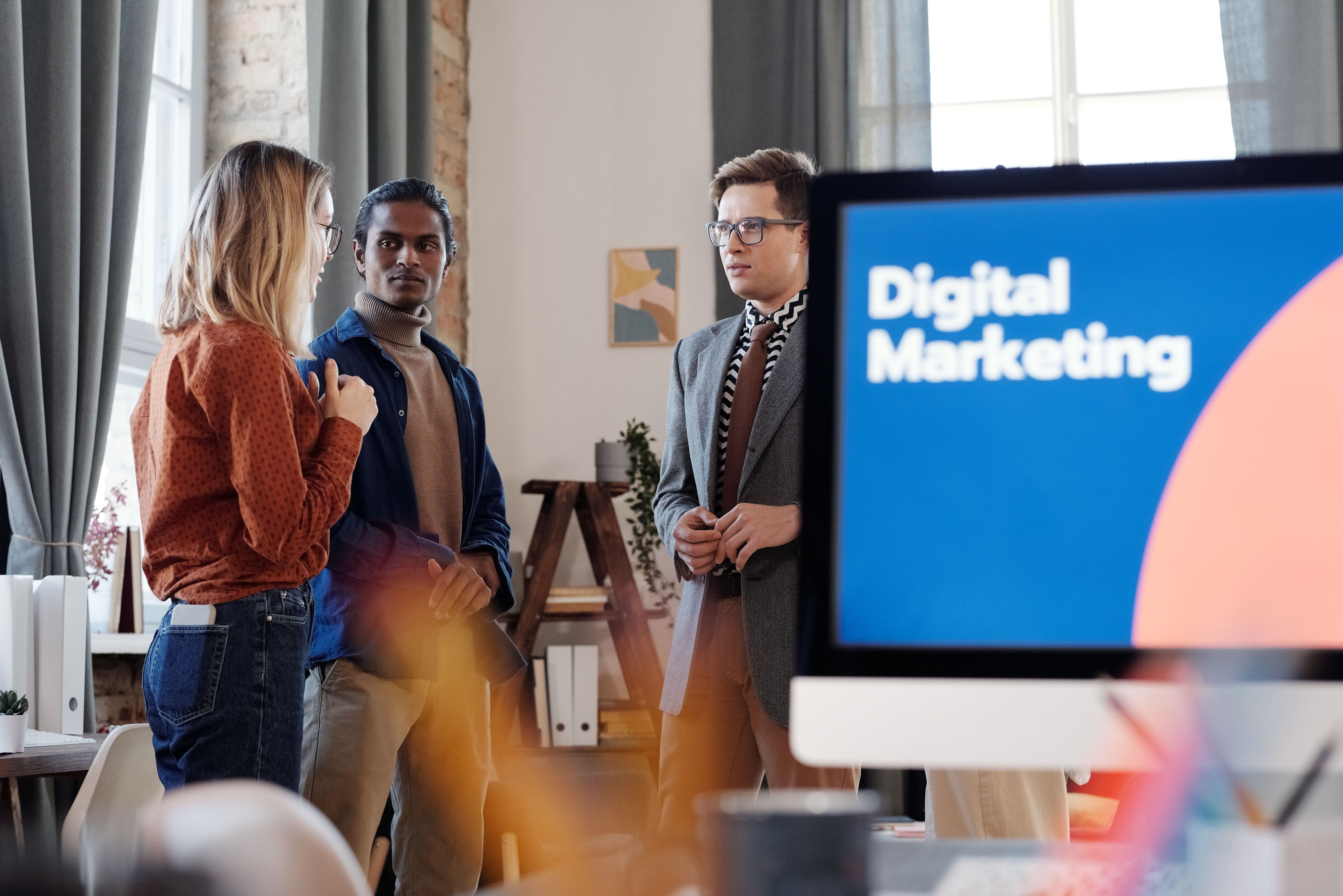 Digital marketing team discussing SEO strategy and pricing in an agency office