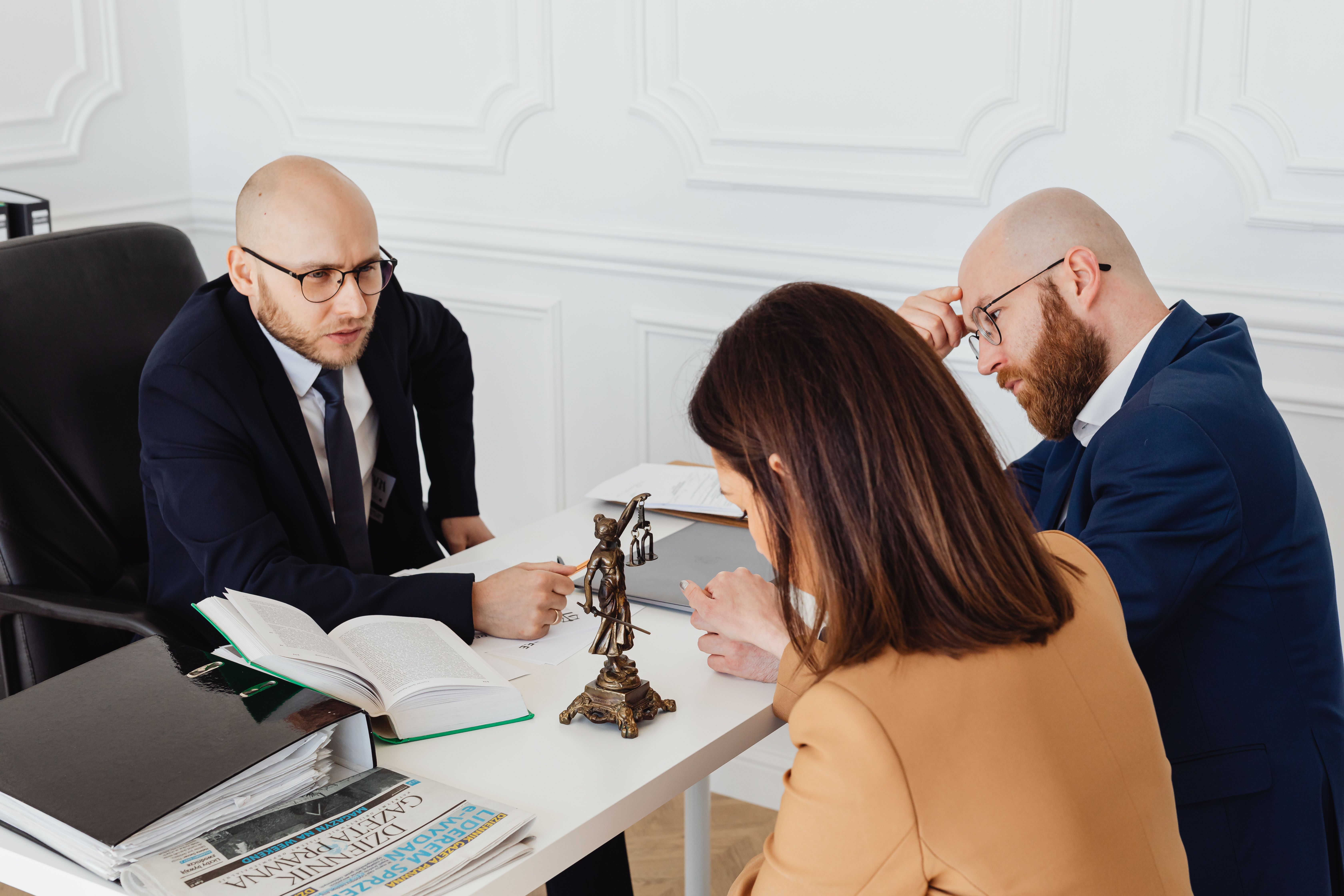Lawyer consulting clients during a serious meeting in a modern professional office